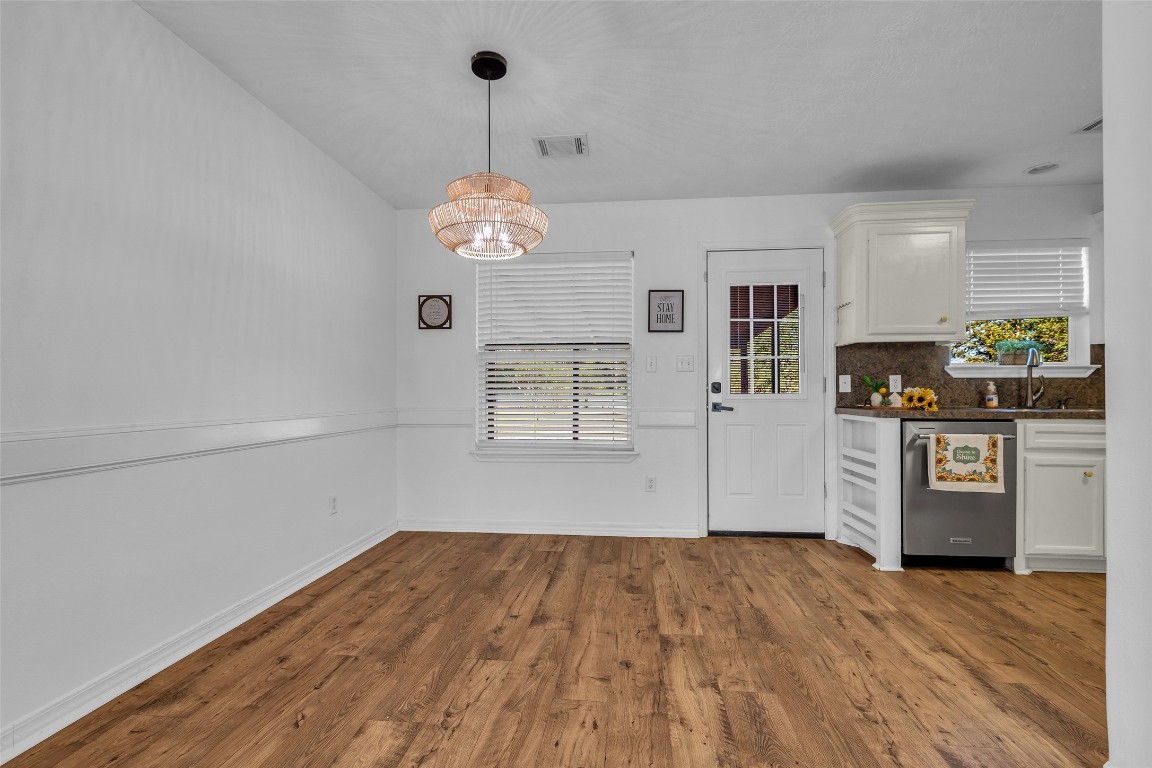 3862 Highline Oaks West Conroe, TX 77306 - Photo 9 of 23 a view of a kitchen with wooden floor and a ceiling fan