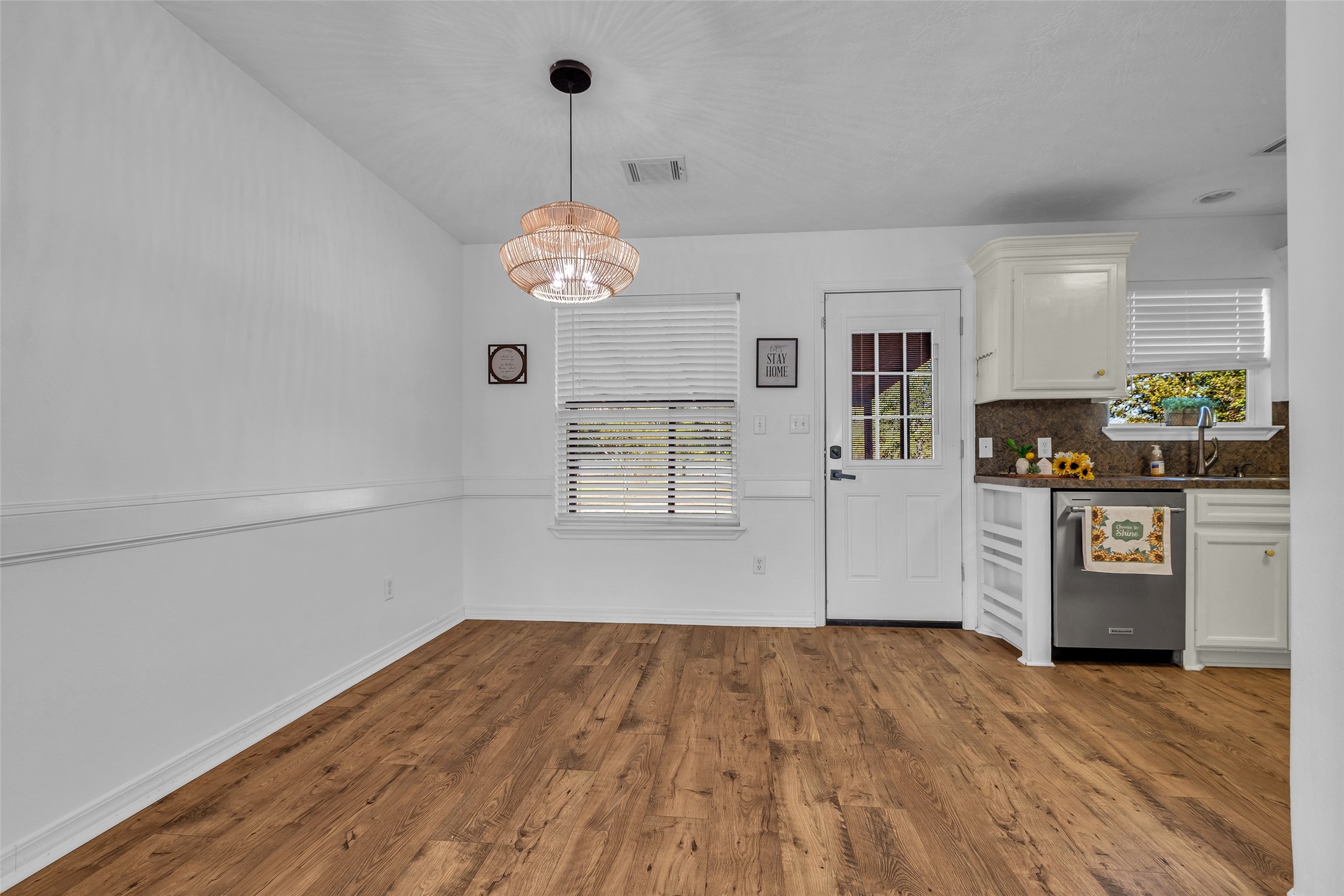 3862 Highline Oaks West Conroe, TX 77306 - Photo 9 of 23 a view of a kitchen with wooden floor and a ceiling fan