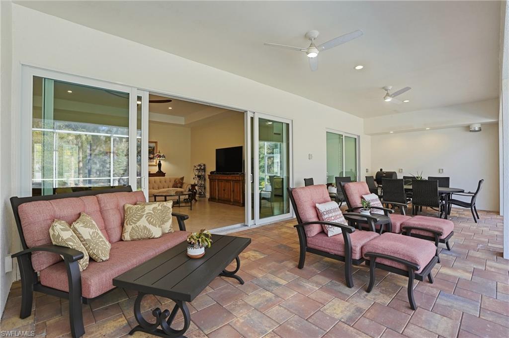 3707 5th Avenue Southwest Naples, FL 34117 - Photo 31 of 45 View of lanai with outdoor dining area, a ceiling fan, and an outdoor hangout area