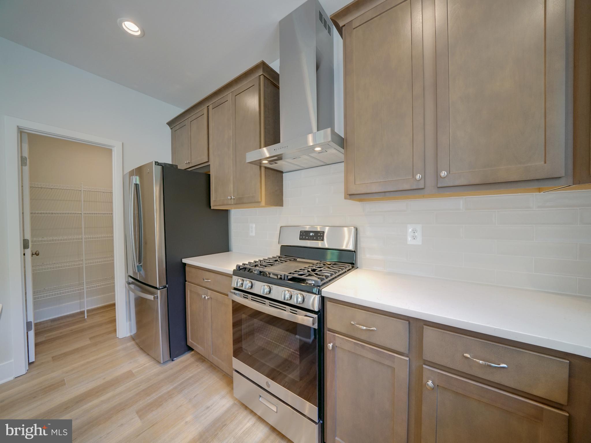 9420 Fairview Avenue Laurel, MD 20723 - Photo 18 of 70 a kitchen with stainless steel appliances granite countertop a stove a refrigerator and a cabinets