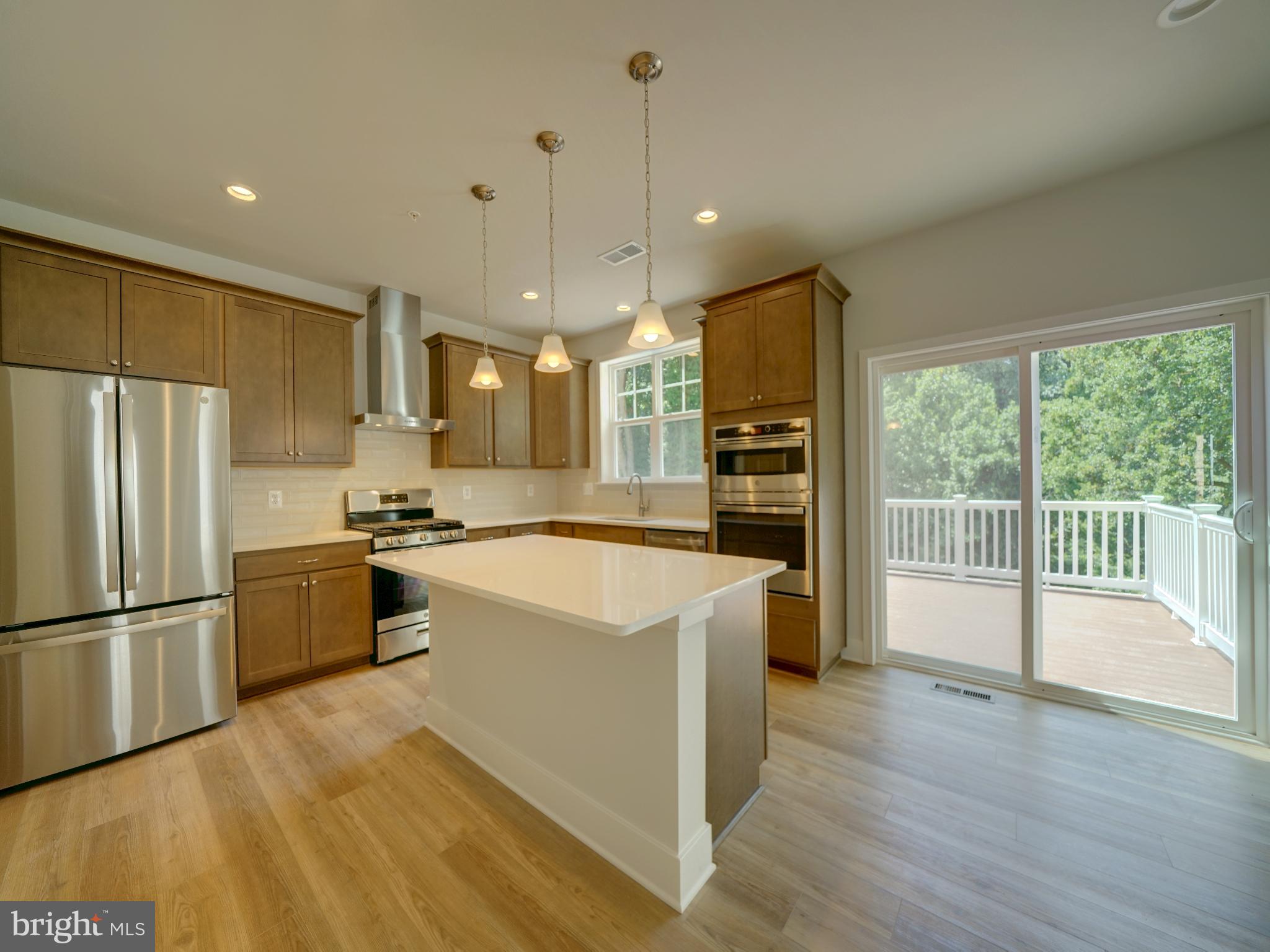 9420 Fairview Avenue Laurel, MD 20723 - Photo 24 of 70 a large kitchen with kitchen island a large counter top space a sink stainless steel appliances and cabinets