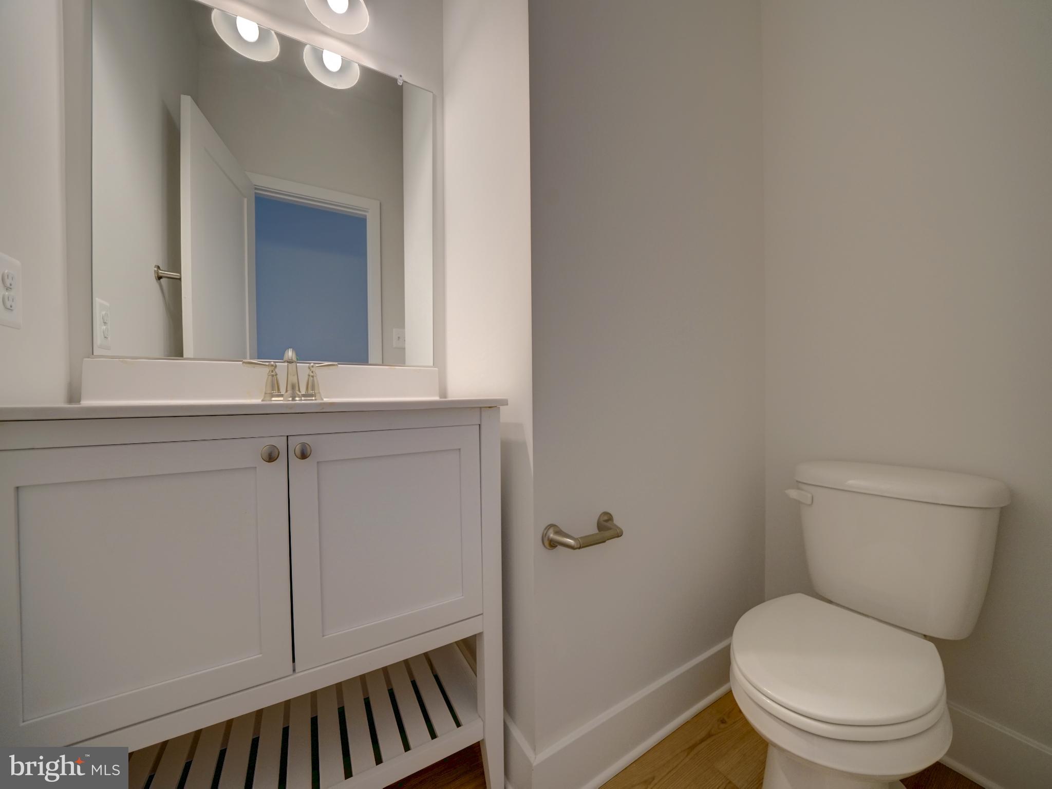 9420 Fairview Avenue Laurel, MD 20723 - Photo 26 of 70 a bathroom with a toilet a sink and mirror
