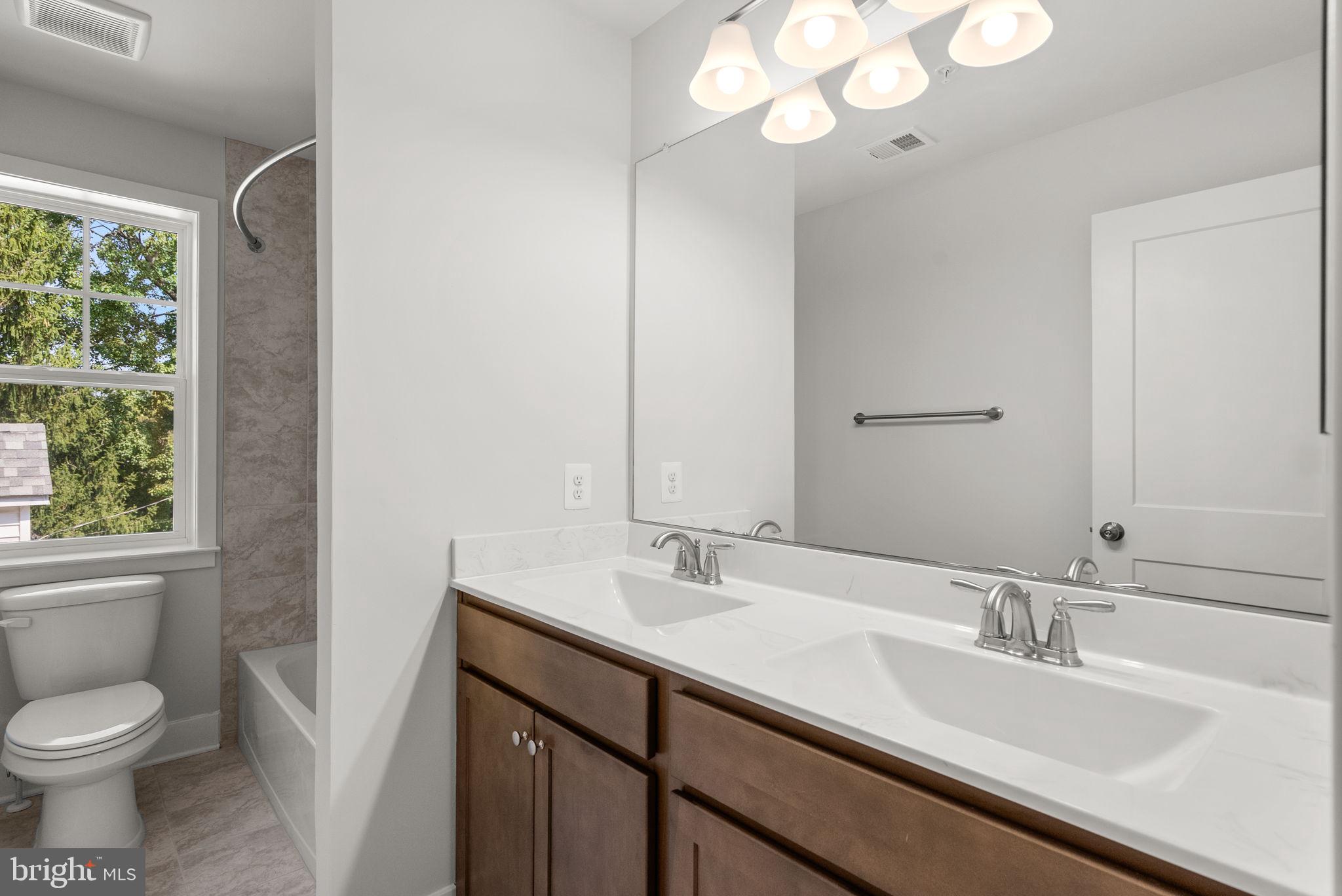 9420 Fairview Avenue Laurel, MD 20723 - Photo 37 of 70 a bathroom with a sink a toilet and a mirror