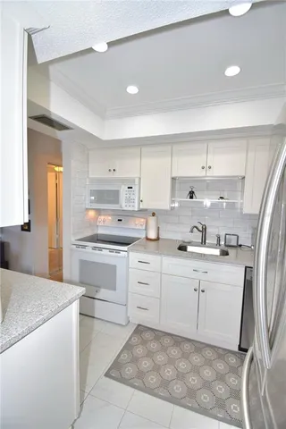 a large kitchen with a large counter top appliances and cabinets