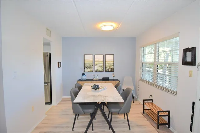 a view of a dining room with furniture window and wooden floor