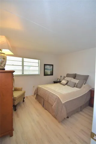 a spacious bedroom with a bed and window