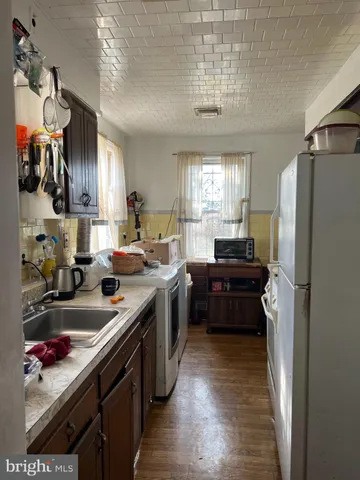 a kitchen with a refrigerator and a sink