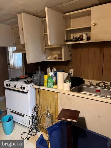 a kitchen with a sink a stove and cabinets