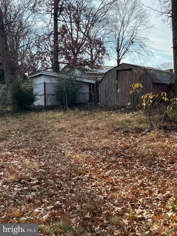 a couple of table and a house with yard in front of it