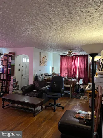 a living room with furniture a window and a piano