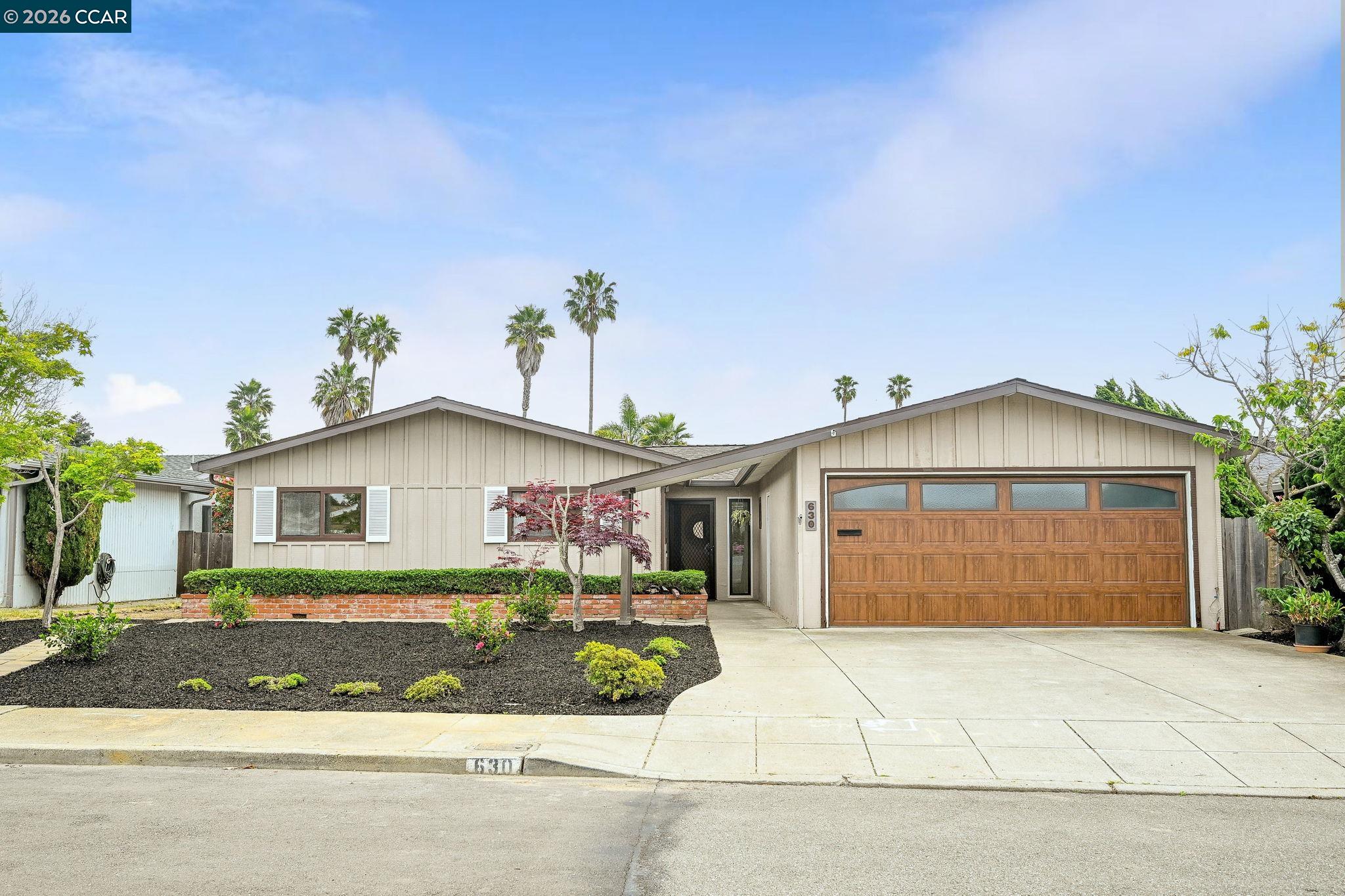 630 Larchmont Isle Alameda, CA 94501 - Photo 1 of 1 a front view of a house with a yard and garage