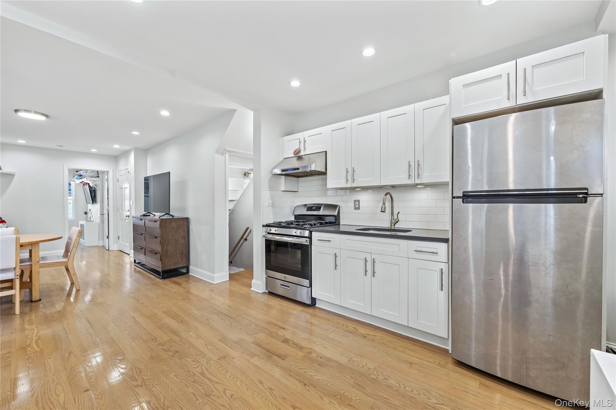 22-29 73rd Street Queens, NY 11370 - Photo 5 of 24 Kitchen - 1st Floor with stainless steel appliances and white cabinets