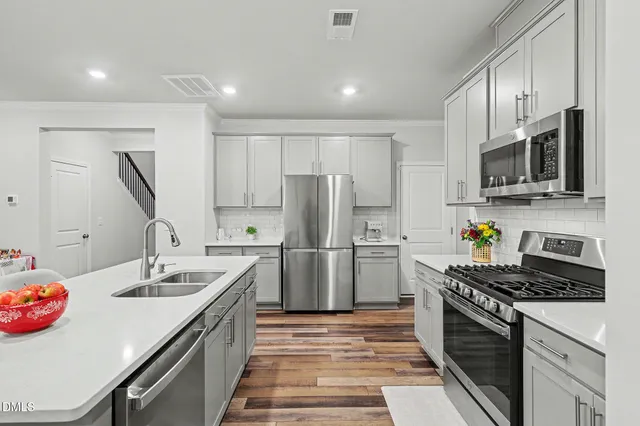 a kitchen with a sink stove and refrigerator