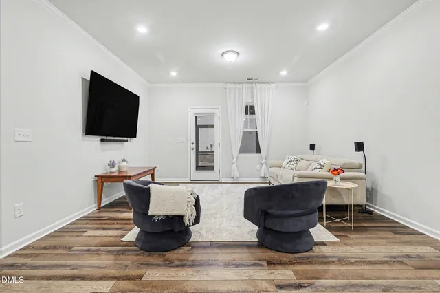 a living room with fireplace furniture and a flat screen tv