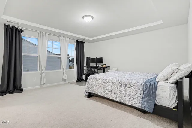 a bedroom with a bed furniture and a flat screen tv