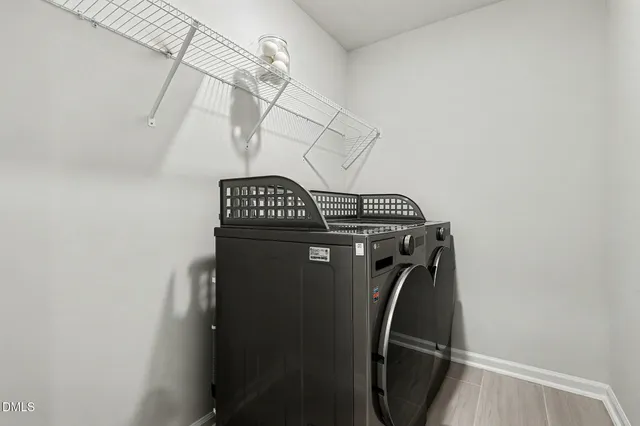 a view of a house with a large window and potted plants