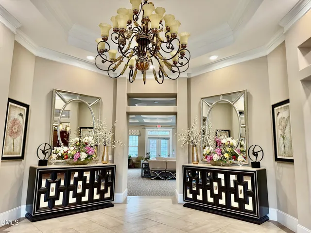 a open kitchen with stainless steel appliances kitchen island granite countertop a dining table chairs and granite counter tops