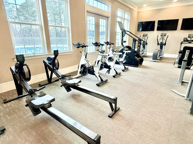 a view of a kitchen with kitchen island a large window cabinets a sink and a counter top space