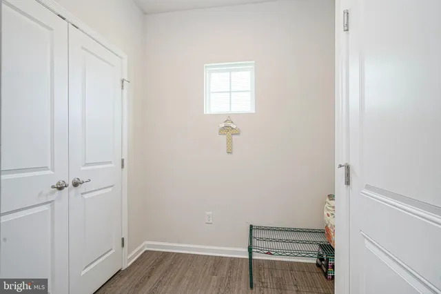 a view of room with hardwood floor and a window