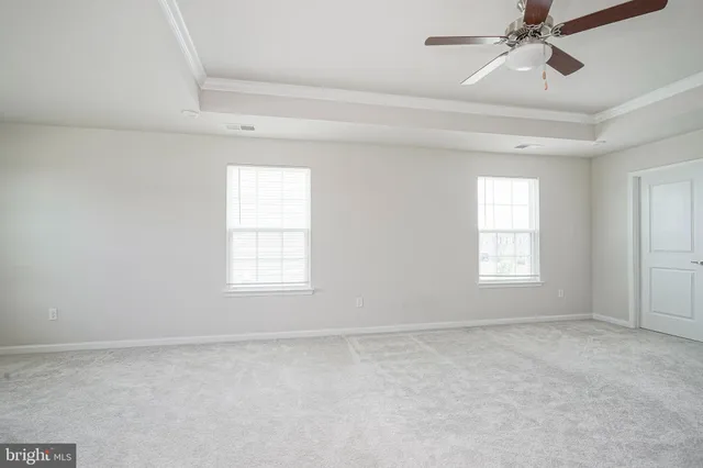 a view of a livingroom with a ceiling fan and window