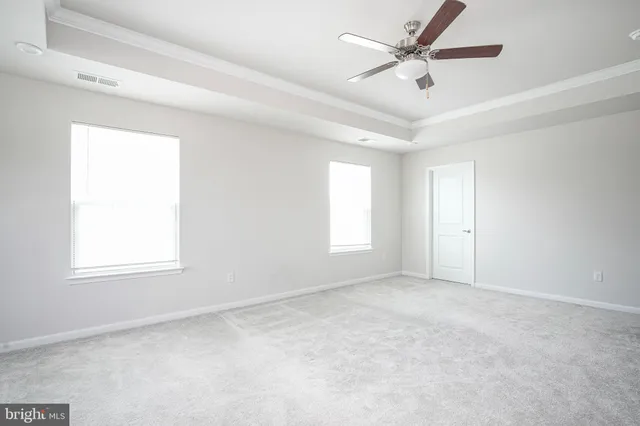 a spacious bathroom with a tub a sink and mirror