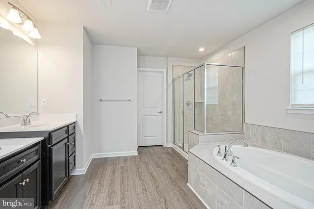 a bathroom with a tub and shower