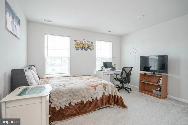 a bedroom with a bed and a television