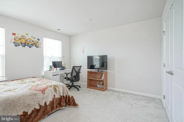 a bedroom with a bed and painting on the wall