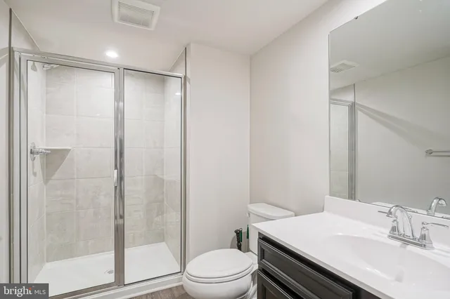 a bathroom with a shower a toilet and a sink