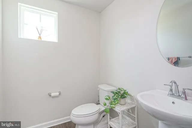 a white toilet sitting next to a bathroom sink