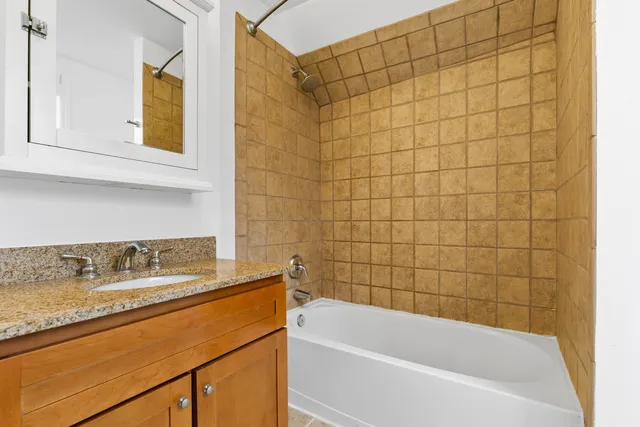 a picture of a bench in front of a wall