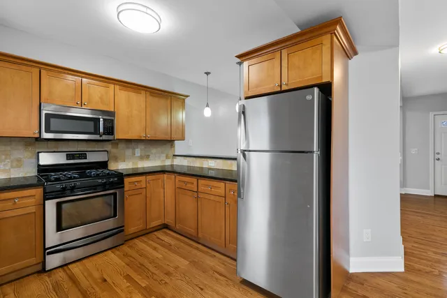 a kitchen with a sink a microwave and cabinets