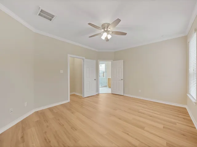a view of an empty room with wooden floor