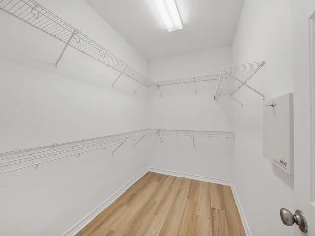 a spacious bathroom with a shower a sink and a mirror