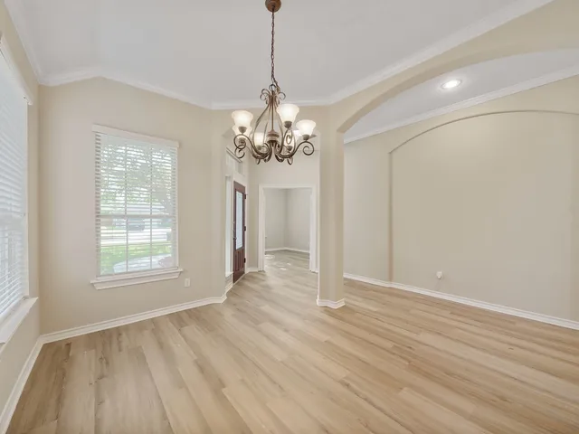 a view of a livingroom with wooden floor and a large window