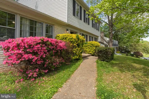 a view of a house with a backyard and garden
