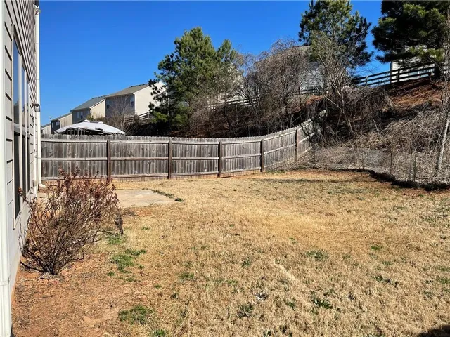 a view of yard with swimming pool and trees