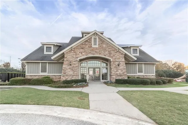 a front view of a house with a garden