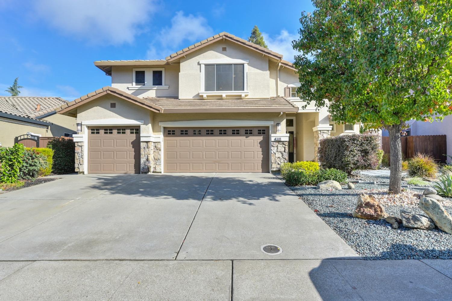 689 Halidon Way Folsom, CA 95630 - Photo 1 of 1 a front view of a house with a yard and garage