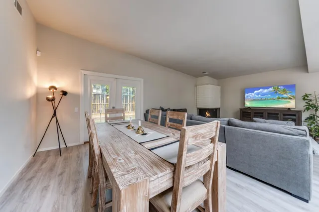 a dining room with furniture and wooden floor