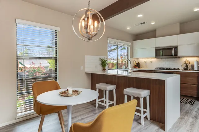 a kitchen with granite countertop a sink and wooden cabinets