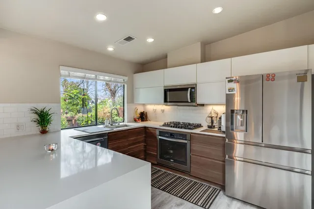 a kitchen with cabinets and steel stainless steel appliances