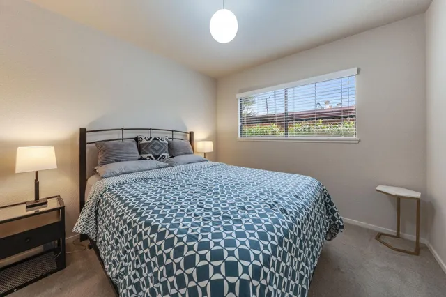 a bedroom with a bed and a lamp