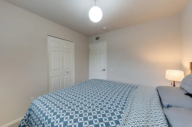 a bedroom with a bed and a window