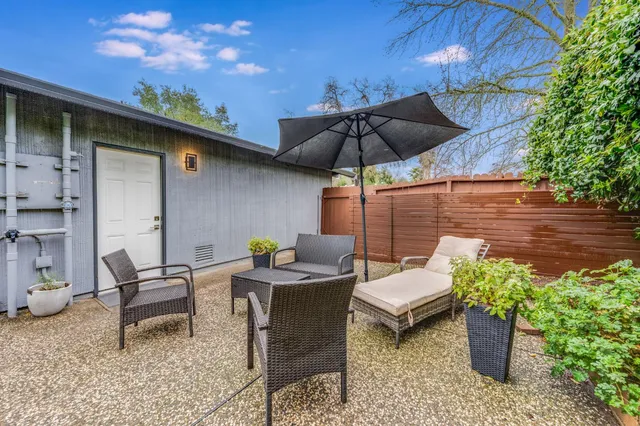 a view of a patio with table and chairs and potted plants