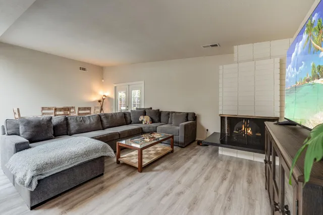 a living room with furniture and wooden floor