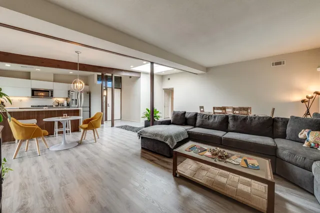 a living room with furniture and a potted plant