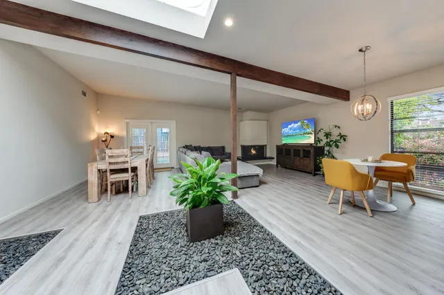 a living room with furniture a chandelier and a chandelier