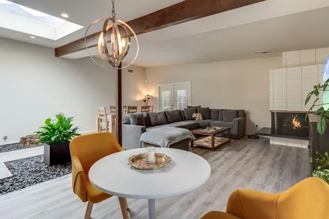 a living room with furniture potted plant and window