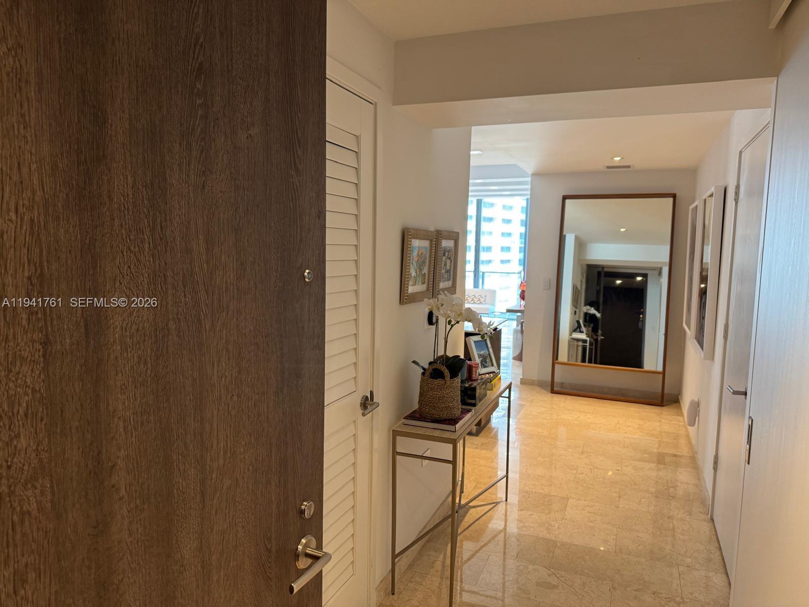 68 Southeast 6th Street, Unit 1109 Miami, FL 33131 - Photo 11 of 23 a living room with furniture and a window